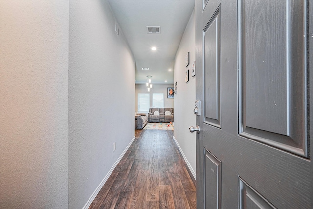 hall featuring recessed lighting, baseboards, visible vents, and dark wood-style flooring