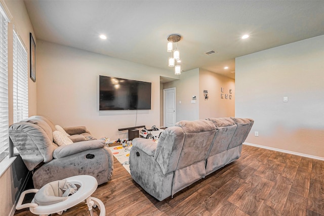 living area with recessed lighting, visible vents, baseboards, and dark wood finished floors