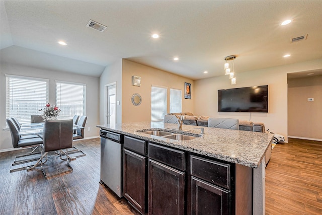 kitchen with a sink, visible vents, stainless steel dishwasher, and wood finished floors