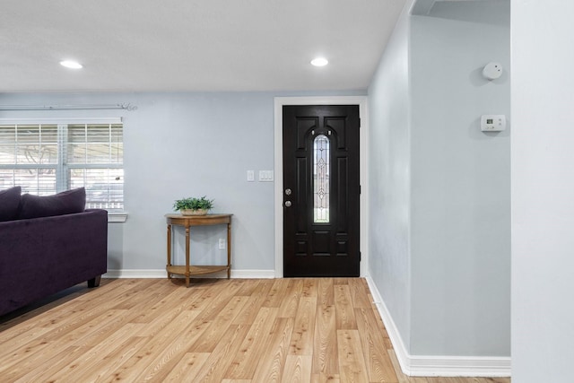 foyer featuring light wood finished floors, recessed lighting, and baseboards