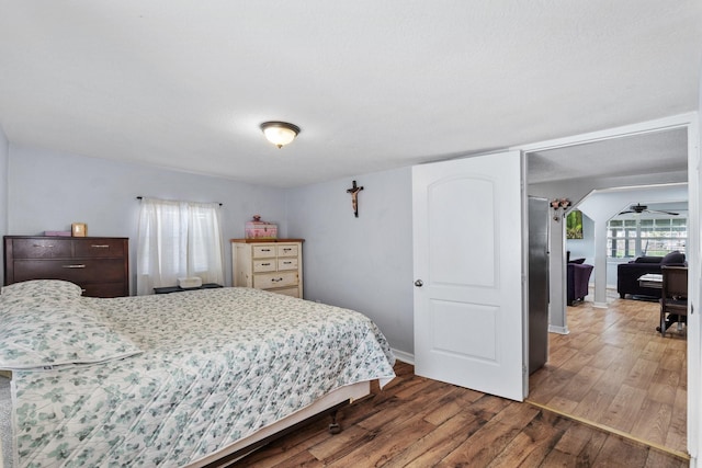 bedroom with baseboards and wood finished floors