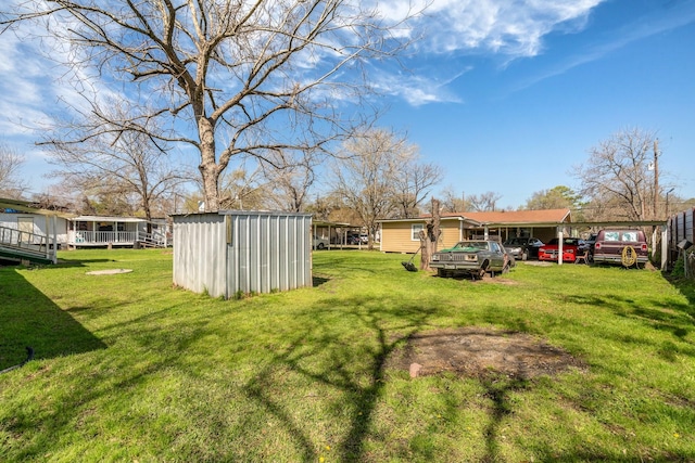 view of yard featuring an outbuilding and a shed