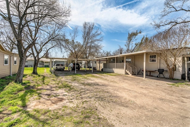 exterior space featuring a carport and driveway