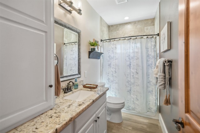 bathroom with shower / bathtub combination with curtain, toilet, wood finished floors, and vanity