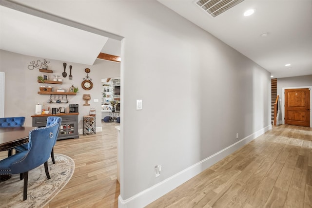 hallway with visible vents, recessed lighting, baseboards, and light wood-style floors