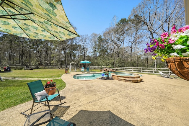 view of patio featuring an in ground hot tub, a fenced backyard, and a fenced in pool