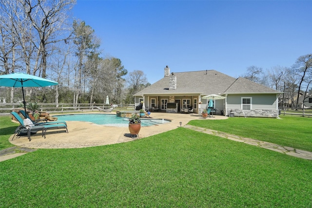 view of swimming pool with a patio, a fenced in pool, a lawn, and fence