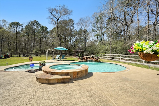 view of pool with a patio area, a yard, a fenced backyard, and a pool with connected hot tub