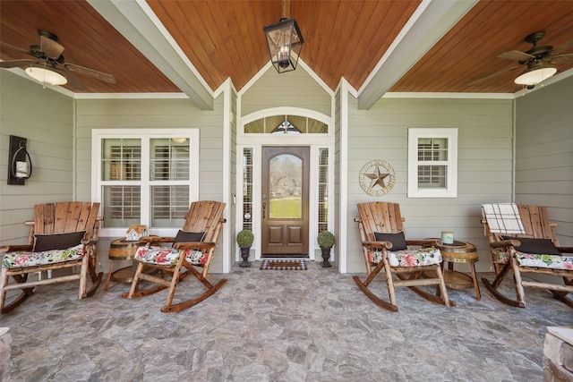 view of exterior entry featuring a porch and ceiling fan