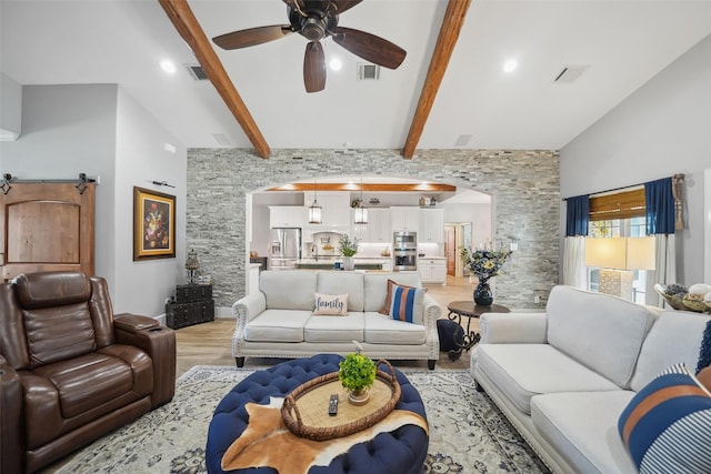 living room with light wood-style flooring, beamed ceiling, visible vents, and ceiling fan