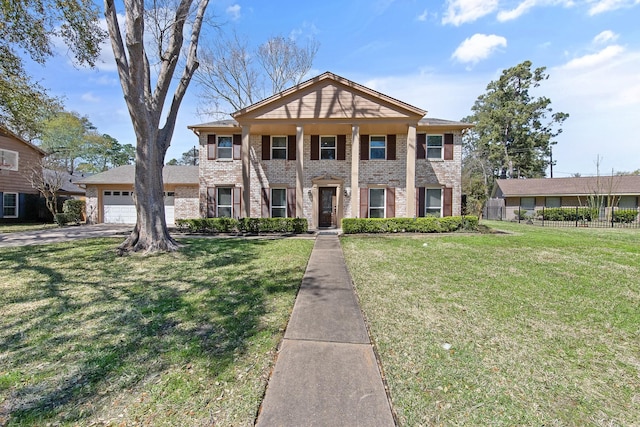 neoclassical home featuring brick siding, an attached garage, a front lawn, and fence