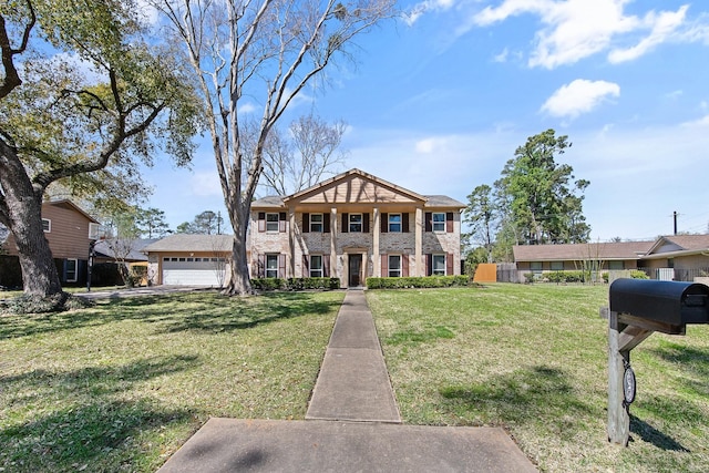 neoclassical / greek revival house featuring a front yard