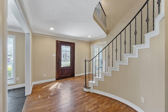 entrance foyer with plenty of natural light, baseboards, and wood finished floors