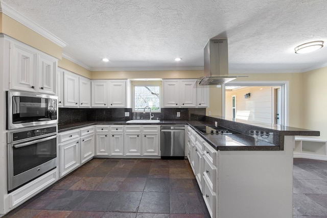 kitchen featuring a peninsula, island exhaust hood, appliances with stainless steel finishes, dark countertops, and backsplash