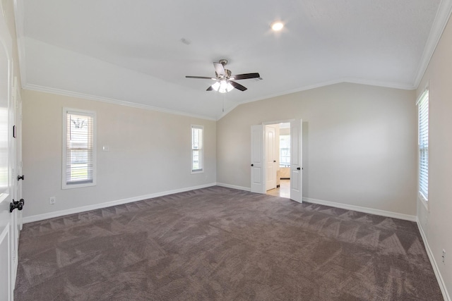 spare room featuring carpet, baseboards, ceiling fan, ornamental molding, and vaulted ceiling