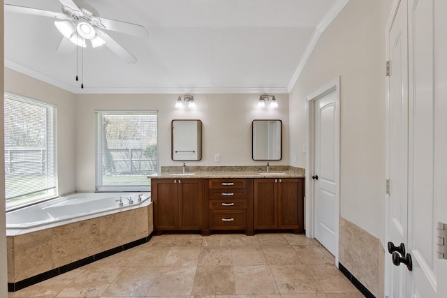 bathroom featuring a bath, ornamental molding, double vanity, and a sink