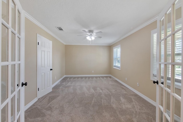 unfurnished room with french doors, baseboards, carpet flooring, and crown molding