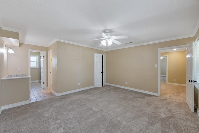 unfurnished room with light carpet, visible vents, baseboards, and ornamental molding