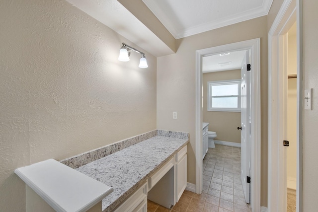 bathroom featuring vanity, baseboards, tile patterned flooring, crown molding, and toilet