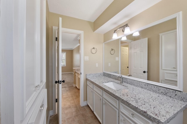 bathroom featuring vanity and baseboards