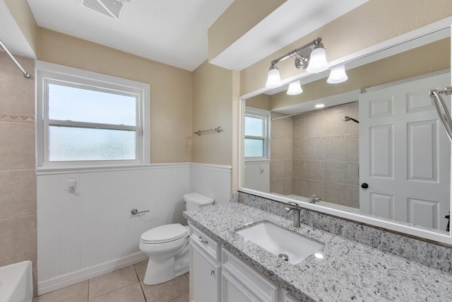 full bathroom with tile patterned floors, visible vents, a wainscoted wall, toilet, and vanity