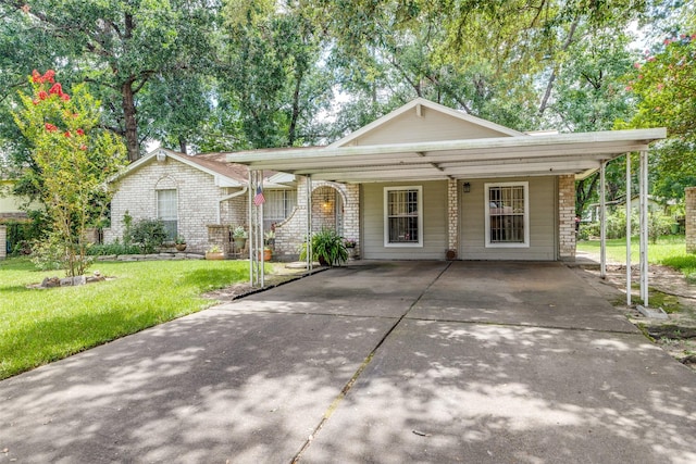 view of front of home with brick siding, concrete driveway, and a front yard