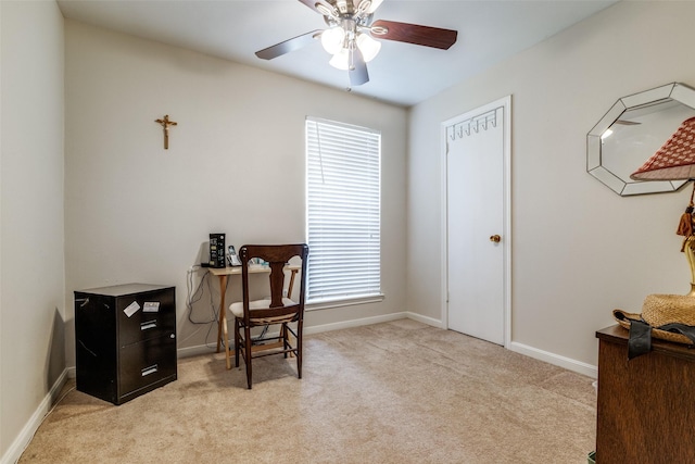 office featuring light carpet, a healthy amount of sunlight, baseboards, and a ceiling fan