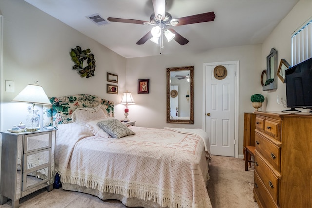 bedroom with visible vents, light carpet, and a ceiling fan