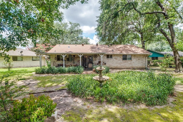 rear view of property featuring brick siding