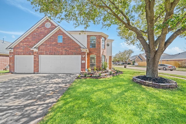 traditional-style home with brick siding, driveway, an attached garage, and a front lawn