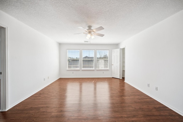 spare room featuring baseboards, a textured ceiling, ceiling fan, and wood finished floors