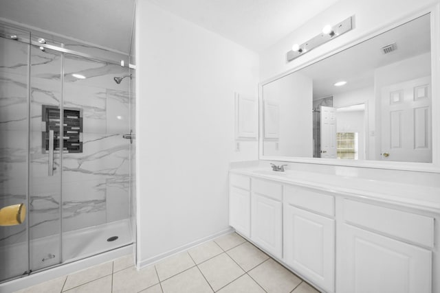 full bath featuring vanity, baseboards, visible vents, a marble finish shower, and tile patterned floors