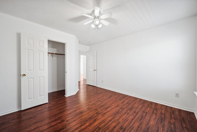 unfurnished bedroom featuring dark wood-style floors, a closet, and baseboards