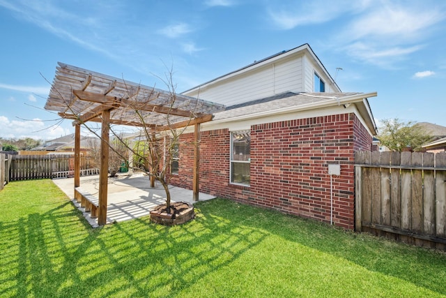 rear view of house with a pergola, a fenced backyard, a yard, brick siding, and a patio area