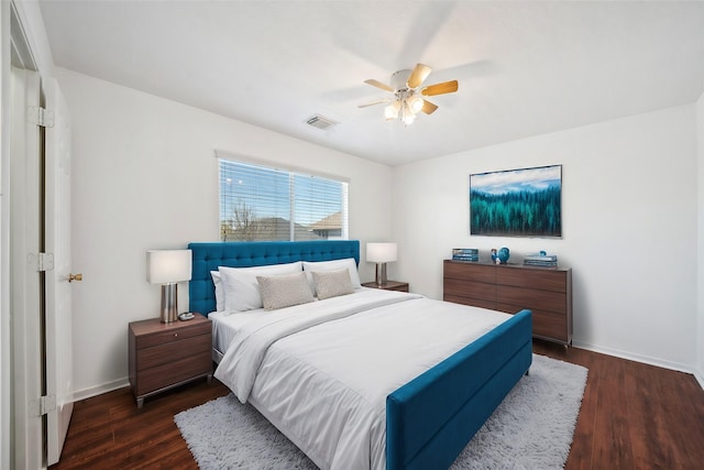 bedroom featuring visible vents, baseboards, dark wood-type flooring, and ceiling fan