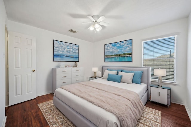 bedroom with visible vents, ceiling fan, baseboards, and wood finished floors