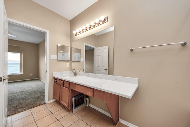 bathroom with tile patterned flooring, vanity, and baseboards