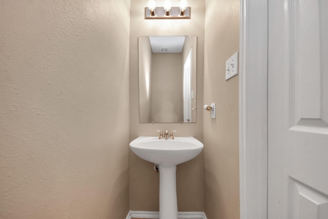 bathroom featuring a textured wall