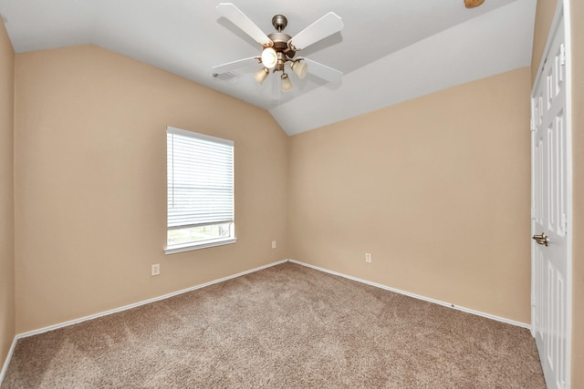 carpeted empty room with baseboards, visible vents, a ceiling fan, and lofted ceiling