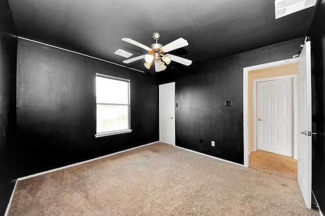 unfurnished room featuring visible vents, carpet floors, and ceiling fan