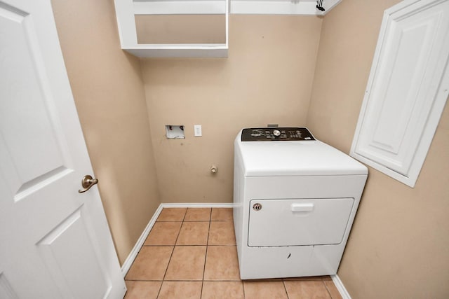 washroom featuring light tile patterned floors, baseboards, washer / clothes dryer, and laundry area