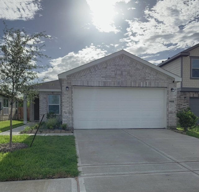 view of front of property with a garage, brick siding, and concrete driveway