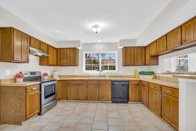 kitchen featuring a sink, under cabinet range hood, stainless steel electric stove, black dishwasher, and brown cabinetry