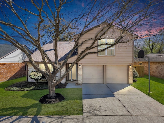 view of front of house with concrete driveway, a yard, brick siding, and an attached garage