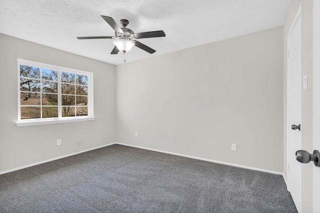 empty room featuring a textured ceiling, carpet flooring, baseboards, and ceiling fan