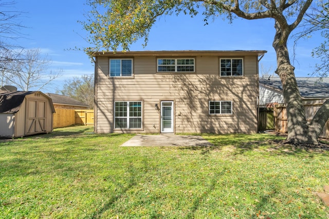 back of property with an outbuilding, a fenced backyard, a shed, a yard, and a patio area