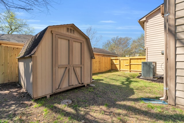 view of shed with a fenced backyard and central AC