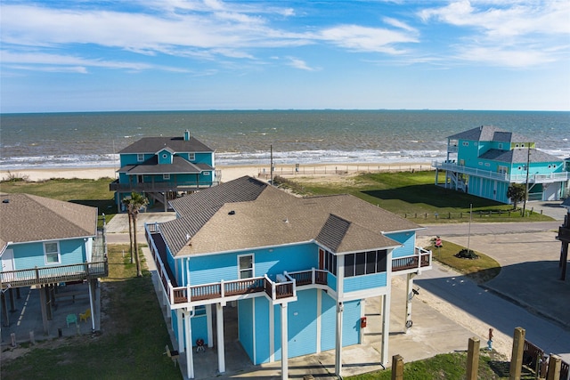 drone / aerial view with a beach view and a water view