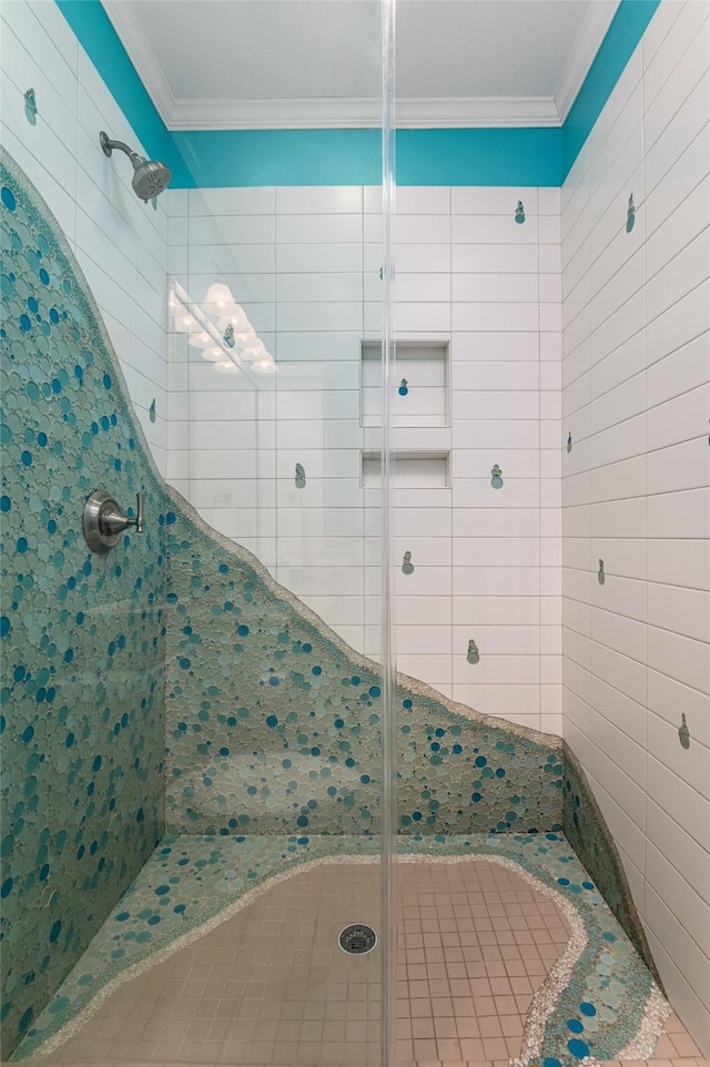 full bath featuring ornamental molding and a shower stall