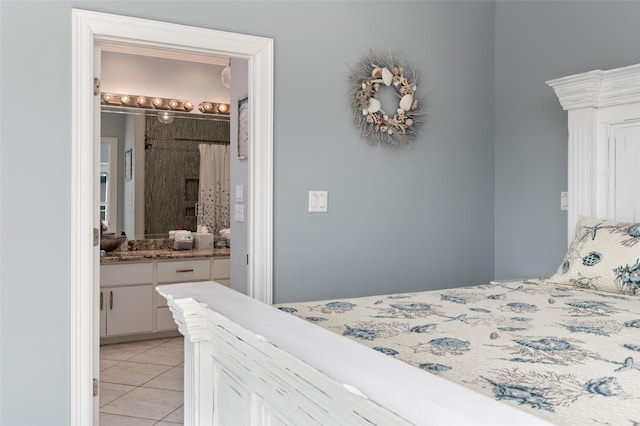 bedroom featuring light tile patterned floors and ensuite bathroom